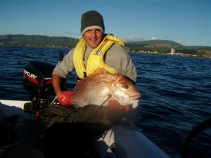 My brother with the 7kg Snapper My brother with the 7kg Snapper caught as the sun was setting. As you can see behind him is the Kapiti Boat Club. This was released